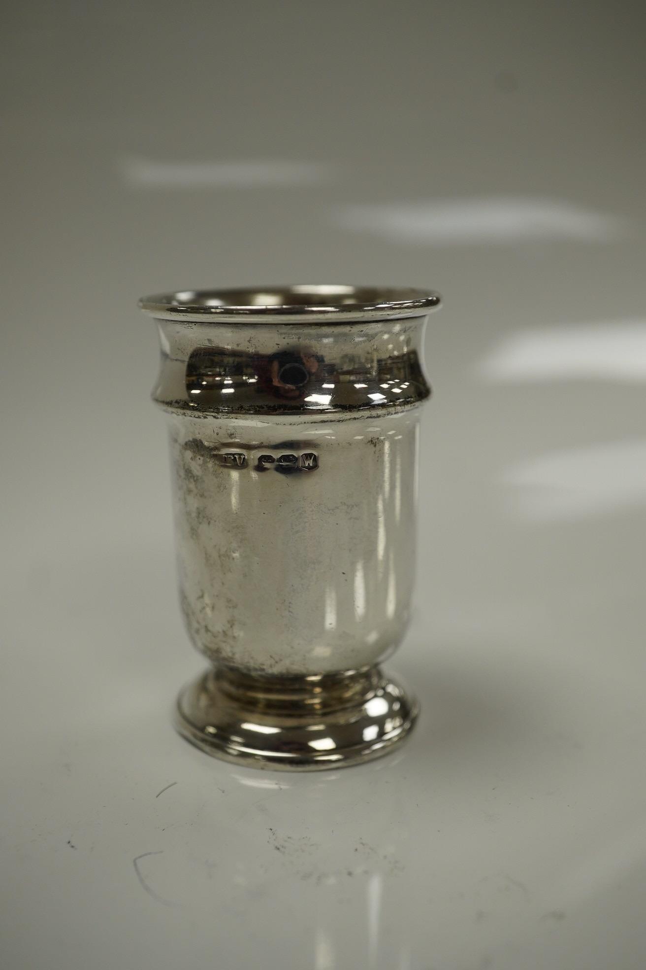 An Elizabeth II silver three piece condiment set, Sheffield, 1964, six assorted silver napkin rings and a stylish Austro Hungarian white metal pill box, by George Adam Scheid, 62mm. Condition - fair